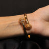 Gold-Toned Open Cuff Bracelet with Lion Medallion & Crystal Sphere